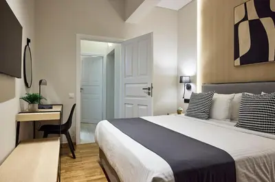 a hotel room with a bed and a desk and a desk at Acropolis Delight Residence II in Athens