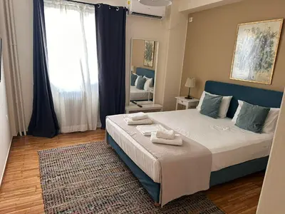 a bedroom with a large bed with towels on it at Check Point - Acropolis Shadow in Athens