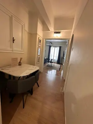 a living room with a table and a hallway at Check Point - Acropolis Shadow in Athens