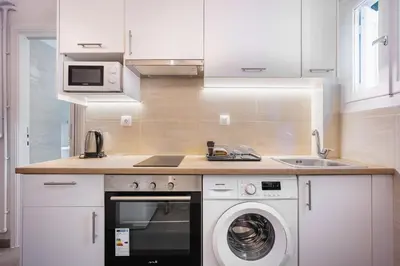 a kitchen with a washing machine and a sink at Galini Acropolis Lux Apartment in Athens