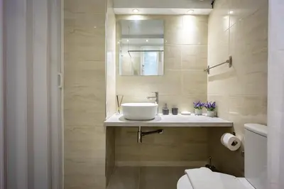 a bathroom with a sink and a toilet at Galini Acropolis Lux Apartment in Athens