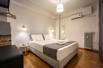 a bedroom with a large bed with two towels on it at Galini Acropolis Lux Apartment in Athens