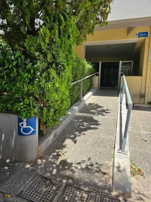 a building with a handicap sign in front of it at Cozy appartment in Neo Faliro, Piraeus in Piraeus