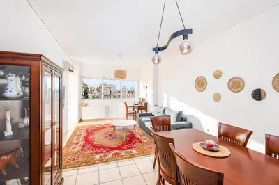 a living room with a table and a couch at Cozy appartment in Neo Faliro, Piraeus in Piraeus