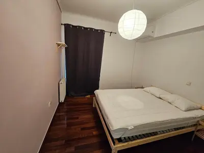 a bedroom with a bed in a room with a window at Cozy appartment in Neo Faliro, Piraeus in Piraeus