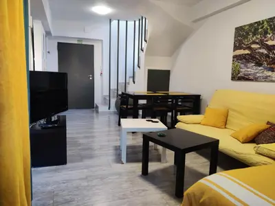 a living room with a yellow couch and a table at SunLoft35 by MPS in Athens
