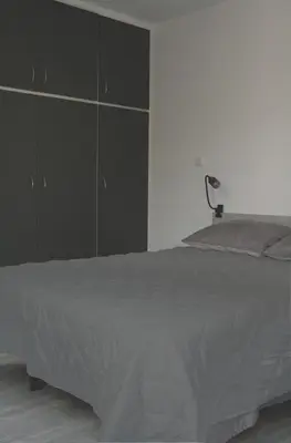 a bedroom with a large bed and a dresser at SunLoft35 by MPS in Athens