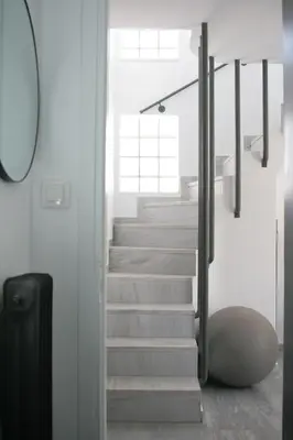 a staircase in a white room with a suitcase at SunLoft35 by MPS in Athens