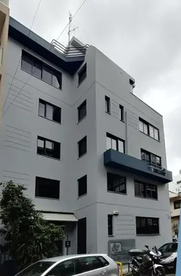 a white building with cars parked in front of it at SunLoft35 by MPS in Athens