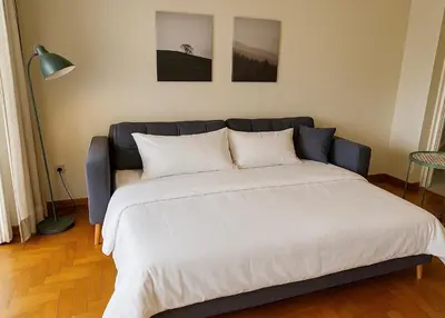 a bedroom with a large bed with white sheets at At Polyla Everything close,nothing loud in Athens