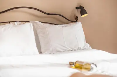 a bed with white pillows and a lamp on it at Elegant Hermes Suite in Athens, by Acropolin in Athens