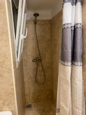 a shower in a bathroom with a shower curtain at Elegant Hermes Suite in Athens, by Acropolin in Athens