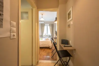 a hallway with a room with a bed and a desk at Elegant Hermes Suite in Athens, by Acropolin in Athens