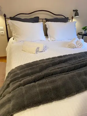a bed with two towels on top of it at Elegant Hermes Suite in Athens, by Acropolin in Athens