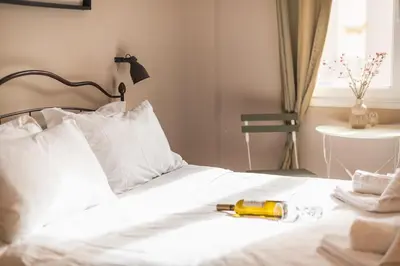 a white bed with a yellow flashlight on it at Elegant Hermes Suite in Athens, by Acropolin in Athens