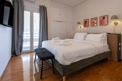 a bedroom with a large bed with towels on it at Modern 1BR - 19min to Center, Fiber Internet in Athens