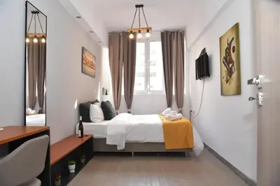 a bedroom with a bed and a window at Aiolou street rooms 2& apartments in Athens