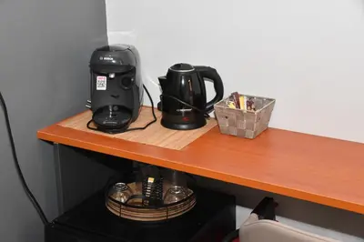 a coffee maker sitting on a wooden counter top at Aiolou street rooms 2& apartments in Athens