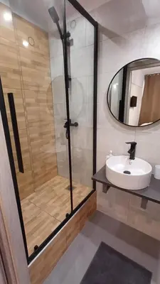 a bathroom with a shower and a sink and a mirror at Aiolou street rooms 2& apartments in Athens