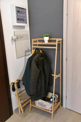 a shelf with a jacket on it next to a wall at Aiolou street rooms 2& apartments in Athens