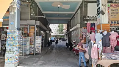 a couple of people standing in front of a store at Aiolou street rooms 2& apartments in Athens