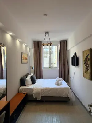 a hotel room with two beds and a mirror at Aiolou street rooms 2& apartments in Athens