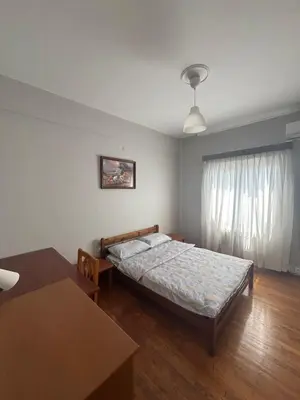 a bedroom with a bed and a table at Onix 1 in Athens
