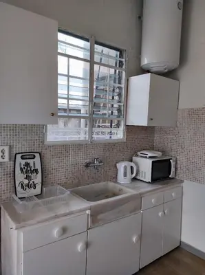 a kitchen with a sink and a microwave at Onix 1 in Athens