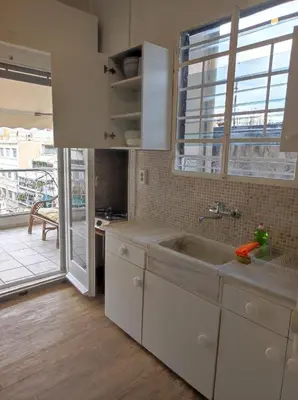 a kitchen with a sink and a large window at Onix 1 in Athens