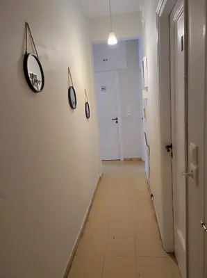 an empty hallway with a white hallway with a mirror at Onix 1 in Athens
