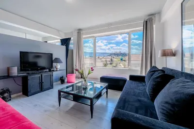 a living room with a couch and a tv at Windows with view in Athens
