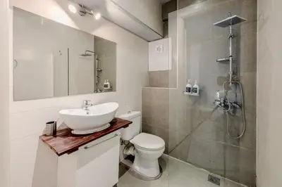 a bathroom with a sink and a toilet and a shower at Windows with view in Athens