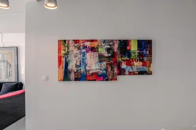 two paintings hanging on a wall in a room at Windows with view in Athens