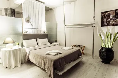 a bedroom with a bed and a vase on the floor at Windows with view in Athens