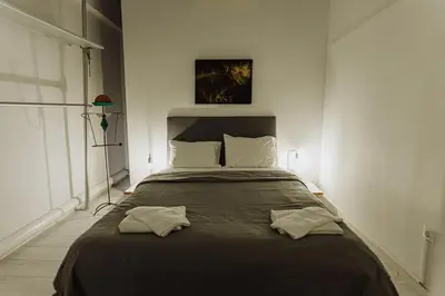 a bedroom with a large bed with two pillows at Windows with view in Athens