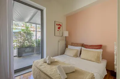 a bedroom with a bed and a large window at mylo akropoli views in Athens