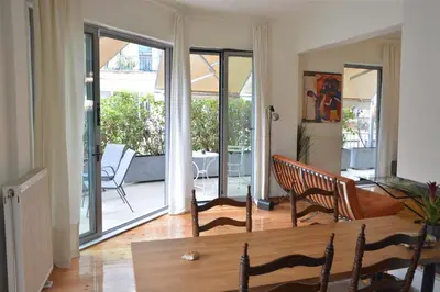 a living room with sliding glass doors leading to a patio at mylo akropoli views in Athens