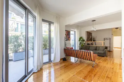 a living room with a couch and large windows at mylo akropoli views in Athens
