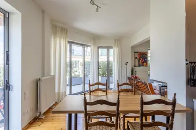 a dining room with a wooden table and chairs at mylo akropoli views in Athens