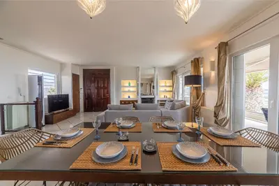 a living room with a table and a couch at Blue Horizon Villa in Kalívia Thorikoú