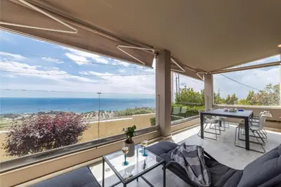 a living room with a view of the ocean at Blue Horizon Villa in Kalívia Thorikoú