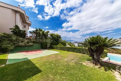 a backyard with a basketball court and a basketball hoop at Blue Horizon Villa in Kalívia Thorikoú