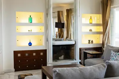 a living room with a couch and a fireplace at Blue Horizon Villa in Kalívia Thorikoú