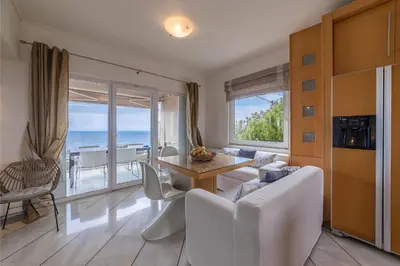 a living room with a view of the ocean at Blue Horizon Villa in Kalívia Thorikoú