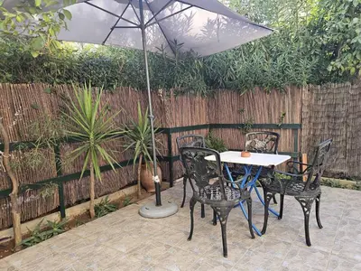 a table and chairs with an umbrella on a patio at Arkadiou Apartments in Chalandri in Athens