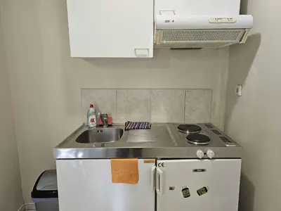 a small kitchen with a sink and a stove at Arkadiou Apartments in Chalandri in Athens