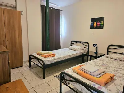 a room with two twin beds in a room at Arkadiou Apartments in Chalandri in Athens
