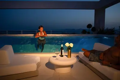 a woman standing in the water in a swimming pool at The ROSE Luxury Penthouse with Private Swimming Pool in Athens