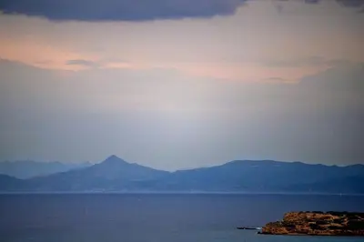 a view of the ocean with mountains in the distance at The ROSE Luxury Penthouse with Private Swimming Pool in Athens