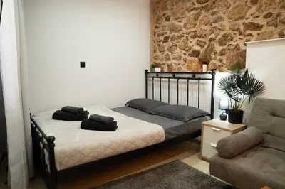 a bedroom with a bed with two towels on it at Tsigros Apartments B in Athens